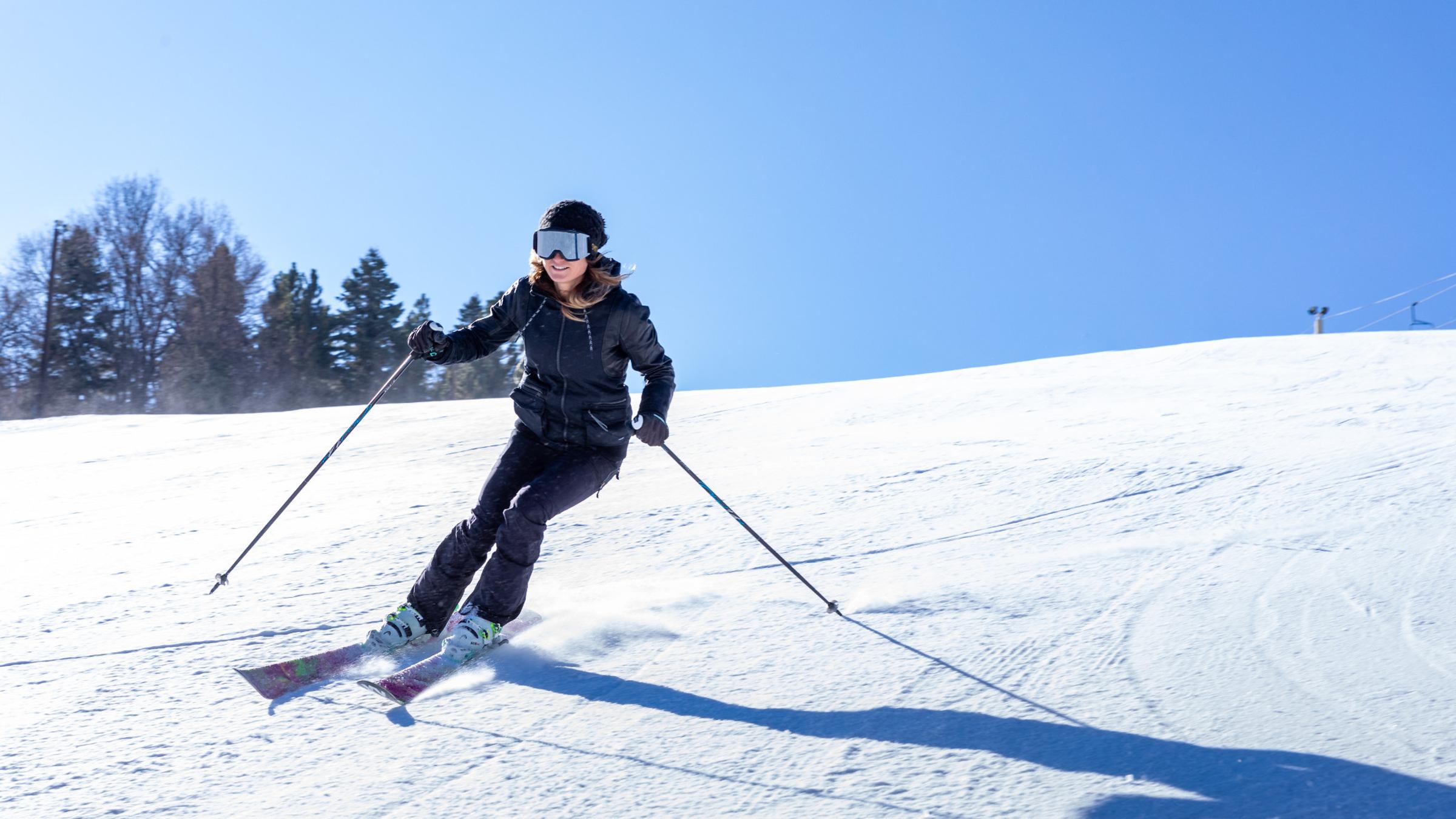 female skier going downhill on a ski slope in big bear